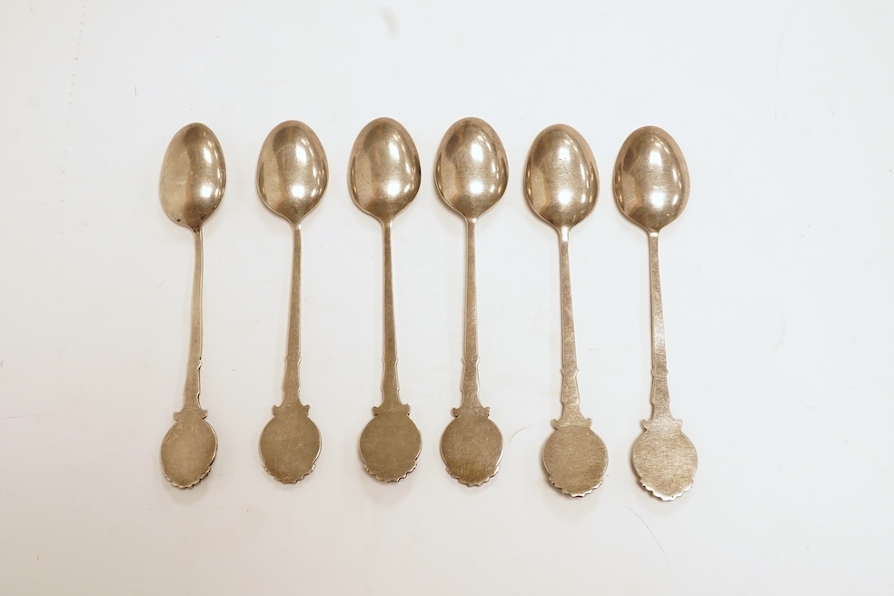 A matched set of six mainly George V silver/white metal and enamel teaspoons, with terminals decorated with dog's heads, 13.6cm. Condition - fair